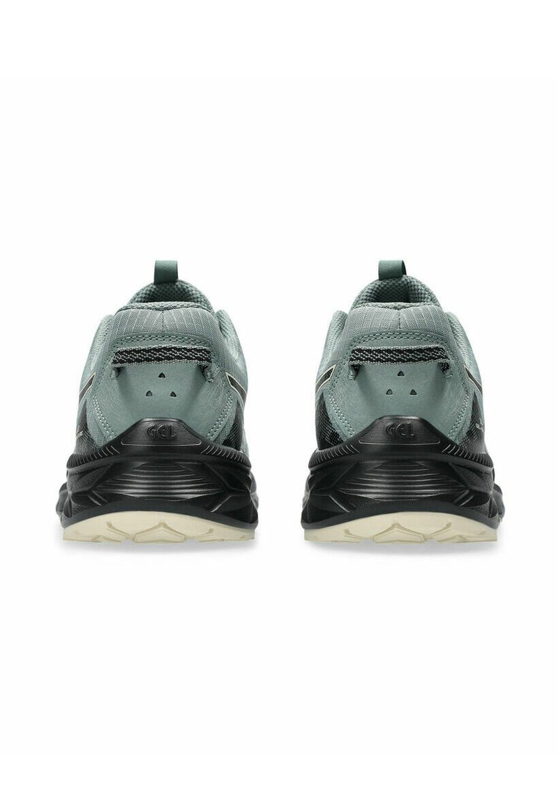 Scarpe sportive con una combinazione di colori verde menta e nero. Presentano una tomaia in rete testurizzata, una suola ammortizzata e un tallone rinforzato.