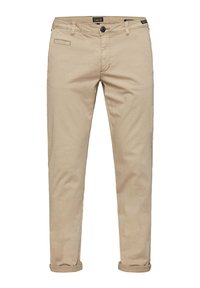 Beige cotton trousers with a slim fit, featuring a front pocket, subtle texture, and rolled cuffs for a modern look.