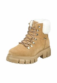 Stivale alla caviglia in suede color tan con un morbido colletto in pelliccia sintetica bianca, occhielli in metallo e suola chunky beige, caratterizzato da lacci decorativi per la chiusura.