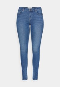 Smala jeans i blekt blå denim med medelhög midja, femficksdesign och kontrasterande sömmar. Slät yta med lätt stretch.