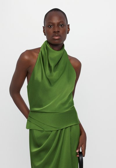 Green satin halter top with draped neck, featuring layered detail at the waist, paired with a matching skirt, smooth texture, and fluid silhouette.
