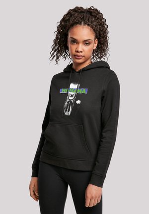 Black hoodie with a front pocket, featuring a graphic design of a character's face and "HAHAHA" text in bright green and blue. Soft fabric.