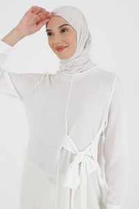 White chiffon dress with long sleeves, tied at the waist with a bow. Complemented by a light-colored hijab. Smooth texture, minimalistic design.