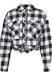 Camicia cropped a maniche lunghe a scacchi in bianco e nero con chiusura a bottoni frontale, due tasche sul petto con bottone, colletto e dettaglio con nodo in vita.