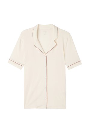Ljus beige kortärmad skjorta med en klämd krage, pärlknappar och en kontrasterande mörk trim längs kragen och ärmarna. Mjuk tygstruktur.