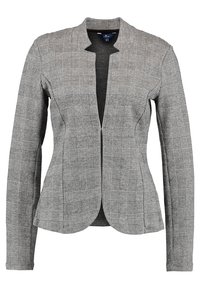 Blazer de cuadros grises con diseño entallado, mangas largas, sin cuello y textura sutil. La parte delantera presenta un diseño abierto y dos costuras laterales.