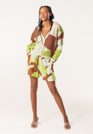 Knit cardigan in light gray, brown, and green geometric patterns; paired with shorts in mint and brown leaf shapes; casual fit; relaxed design.