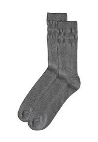 Calzini grigi a coste con una texture liscia, punta rinforzata e bordo elastico per una vestibilità sicura. Adatti per un abbigliamento casual o formale.