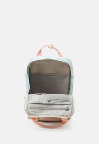 Backpack with a light blue exterior, pink handles, and a gray interior. Features a main compartment and a zippered pocket.