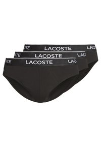 Schwarze Baumwollslips mit weitem elastischen Bund und weißem "Lacoste"-Logo. Glatte Textur mit taillierter Passform für maximalen Komfort.