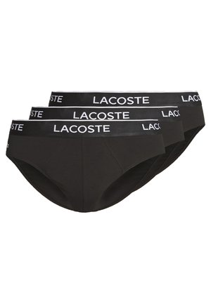 Svarta bomullsboxershorts med ett brett elastiskt midjeband med vitt "Lacoste"-tryck. Slät textur med en åtsittande design för komfort.