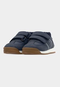 Παιδικά παπούτσια σε ναυτικό μπλε χρώμα, κατασκευασμένα από συνθετικό υλικό, με δύο ρυθμιζόμενους ιμάντες με αυτοκόλλητο κούμπωμα, λευκή ενδιάμεση σόλα και καφέ ελαστική εξωτερική σόλα με υφή.