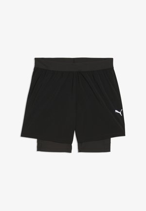 Shorts de sport noirs avec une taille élastique et un collant de compression intégré, arborant un logo Puma blanc sur la jambe droite.