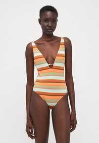 Striped one-piece swimsuit in orange, turquoise, and brown. Designed with a deep V-neck and wide shoulder straps, featuring a ribbed texture.