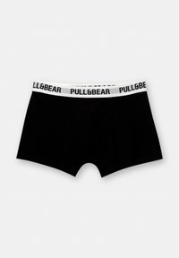 Schwarze Boxershorts aus weichem Stoff, mit einem weißen elastischen Bund, auf dem der schwarze Text "PULL&BEAR" aufgedruckt ist. Glatte Textur, figurbetonte Form.