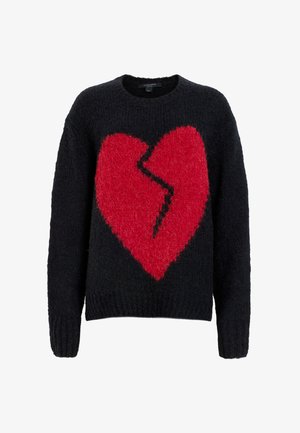 Suéter negro de punto con un gran diseño de corazón rojo y una línea negra irregular en el centro. Tejido texturizado y puños acanalados.