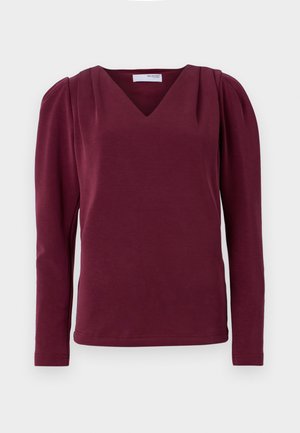 Bordeaux langermet topp med V-hals og rynkede skuldre. Mykt stoff, tettsittende silhuett med sidespalter og ren kantfinish.