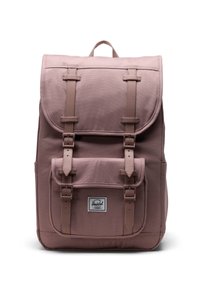 Vaaleanpunainen reppu, jossa on kanvaalipinta, yläläppä, kaksi etutaskua ja säädettävät hihnat, etupuolella oleva logotägi.