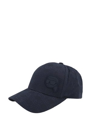 Zwarte baseballpet met gestructureerd geometrisch patroon en een verhoogd logo van een gestileerd gezicht met een bril op het voorpaneel.