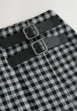 Black and gray checkered fabric with two wide black leather straps and square metal buckles on a structured surface.