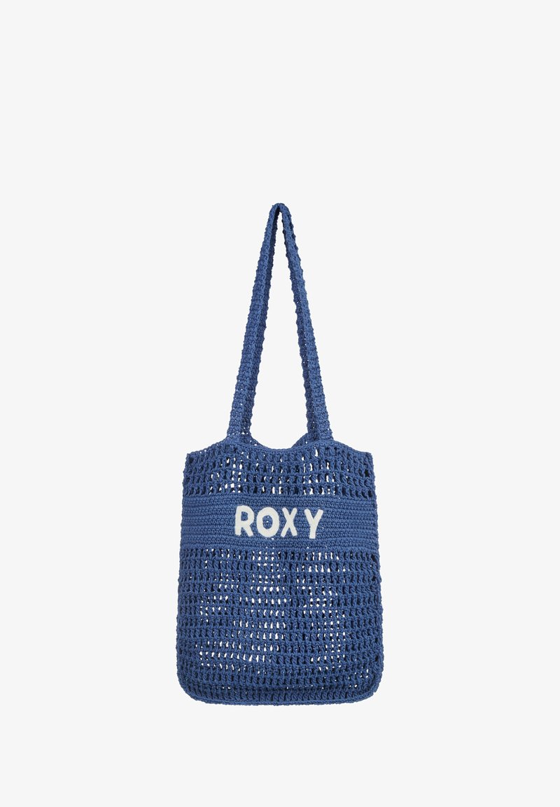 Blue woven tote bag with a solid upper section featuring "ROXY" in white. Designed with two sturdy handles for carrying.