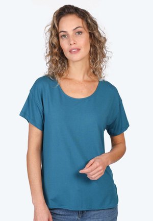 Türkisfarbenes T-Shirt mit kurzen Ärmeln, rundem Halsausschnitt, lockerer Passform und weichem Stoff. Das Shirt hat eine glatte Textur und Seitenschlitze.