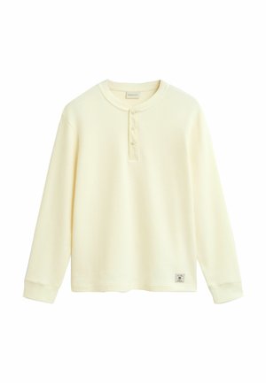 Lange mouwen katoenen shirt in lichtbeige met een gestructureerd wafelpatroon, voorzien van een ronde hals, een vijfknopenlijst en een logotag op de zoom.