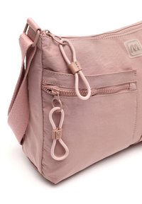 Ružová látková taška na rameno s hlavným oddelením na zips, prednou vreckom a textúrovanými detailmi. Obsahuje nastaviteľný popruh a kovový očko.