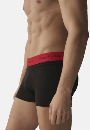 Male torso wearing black boxer briefs with a red waistband labeled "Vincent Creation," shown against a plain light background.