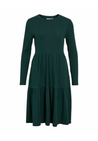 Robe à manches longues, de couleur vert foncé, avec un corsage ajusté et une jupe évasée à volants. Fabriquée en tissu côtelé. Encolure ronde et sans embellissements supplémentaires.