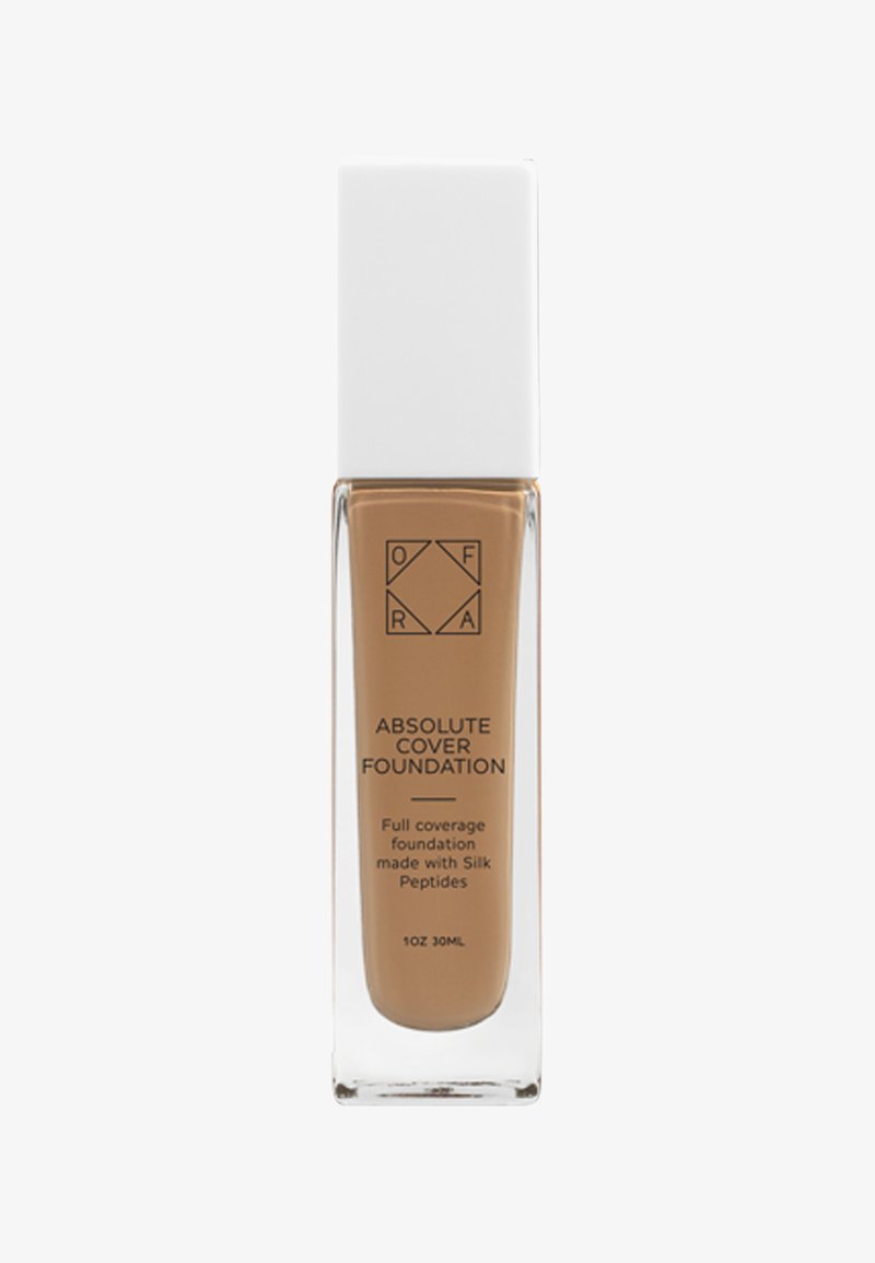 Flacon de fond de teint OFRA Absolute Cover avec bouchon blanc et liquide brun clair à l'intérieur, étiqueté couvrance totale avec peptides de soie.