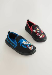 Black slip-on shoes for kids, one with blue trim and Sonic the Hedgehog, the other red-trimmed with Shadow the Hedgehog.