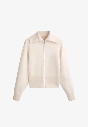 Világos bézs színű, cipzáros pulóver széles gallérral. Puha kötött anyagból készült, a mandzsettákon és az alján bordázott részletekkel.