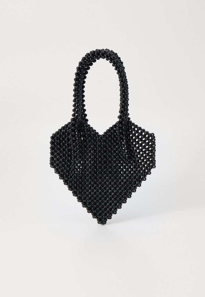 Black beaded handbag with a heart shape and intricate woven design. Features a double handle and a textured surface.