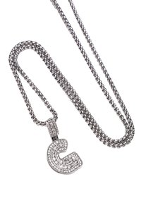 Sølvsmykke med en kæde og en vedhæng af bogstavet 'C', dekoreret med kubisk zirconia og med en poleret finish, der viser et detaljeret geometrisk design.