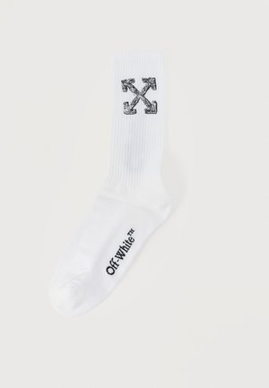 Hvit sokk til mannskap med svart Off-White™-logo på foten og svart design med kryssede piler på legg.