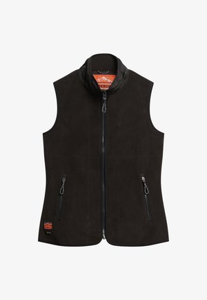 Chaleco negro sin mangas hecho de tela suave, con un cuello alto, cremallera en el frente y dos bolsillos laterales con cierres de cremallera. Detalle del logo de montaña.