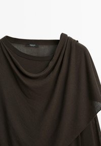 Brown loose-fitting top with a draped neckline, soft texture, and a lightweight knit material. Features a subtle sheen and smooth edges.
