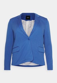 Niebieska marynarka o dopasowanym kroju, zapinana na jeden guzik, z dwoma przednimi kieszeniami. Wnętrze wyściełane jest paskowanym podszewką dla dodatkowego efektu.