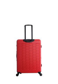 Red hard-shell suitcase with a textured hexagonal pattern, retractable black handle, four black wheels, and side handles.