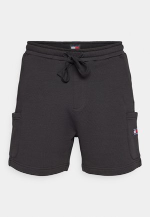 Mustad must shorts, mille kummiga vöökoht, kaks külge taskut ja väike logo silt punaste, valgete ja siniste aktsentidega. Pehme tekstuur.