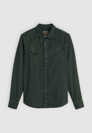 Green denim shirt with long sleeves, snap buttons, western-style yoke, and embroidered accents on shoulders. Two front pockets.