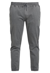 Harmaat puuvillasekoitehousut, joissa joustava vyötärönauha ja kiristysnauha, kapenevat lahkeet, sivutaskut ja teksturoitu kangas.