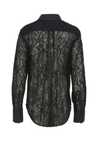 Blusa nera in pizzo con colletto e polsini neri solidi, caratterizzata da motivi floreali, maniche lunghe e orlo leggermente curvato.