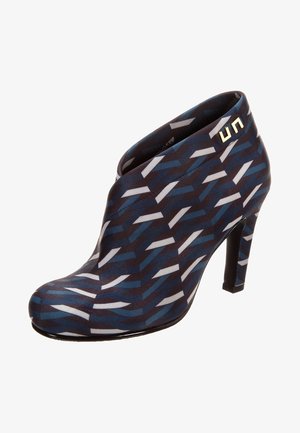 Blue and black ankle boot with a geometric pattern, smooth textile upper, pointed toe, and a stiletto heel. Gold hardware accent included.
