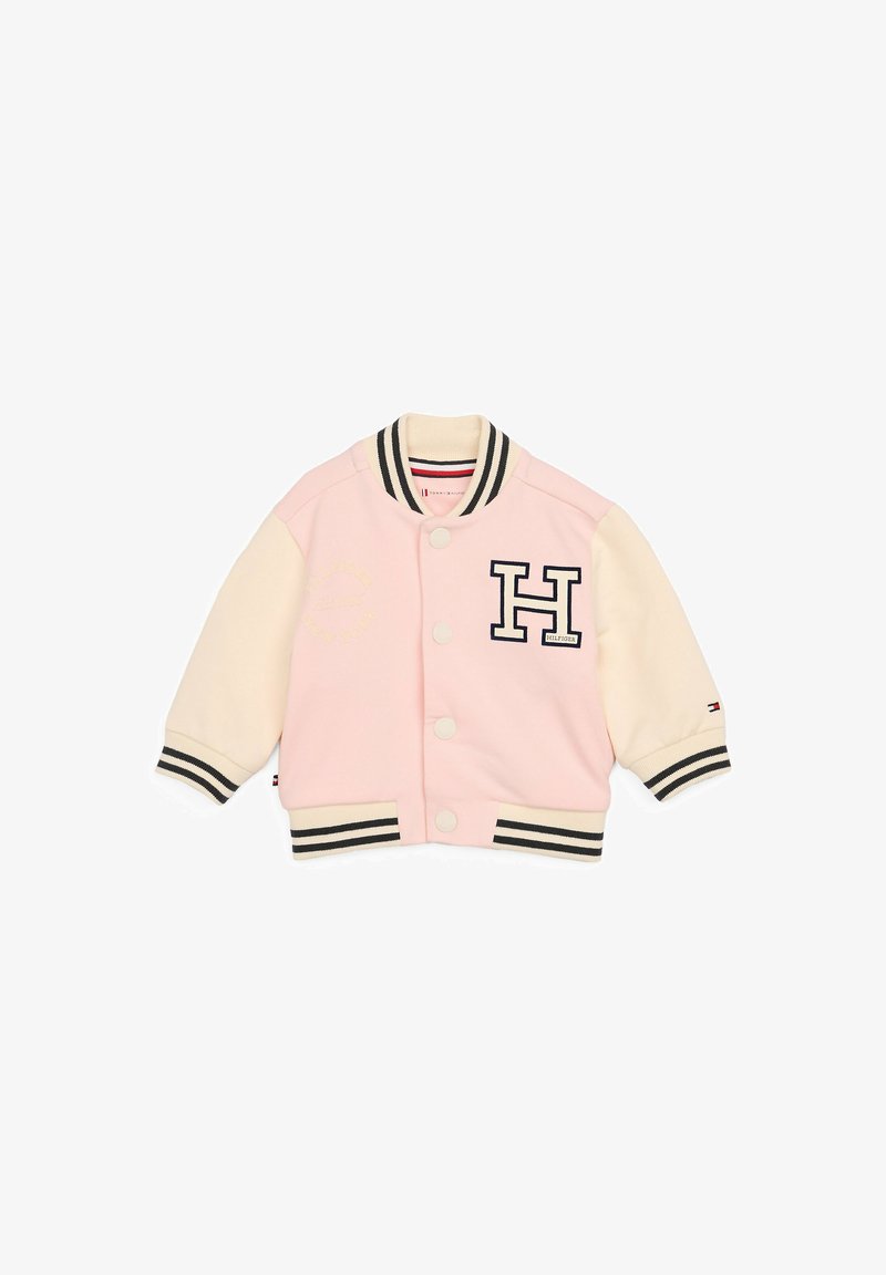 Giacca varsity rosa e crema con strisce nere, bottoni a scatto e logo ricamato "H". Presenta un tessuto morbido e polsini a costine.