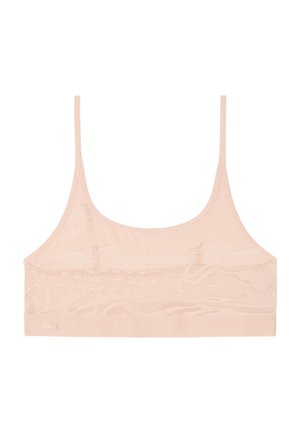 Light pink lace bralette with thin shoulder straps and a wide elastic band featuring the Lacoste logo and crocodile emblem.
