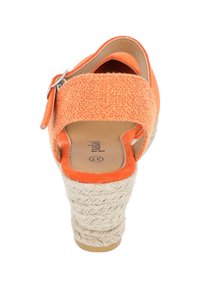 Orange fabric wedge sandals with a textured strap, adjustable silver buckle, and woven jute heel. Soft interior lining for comfort.