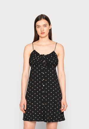 Vestido de verão preto com flores, com alças finas, corpete franzido, botão à frente e pequenos padrões de flores em cores claras.
