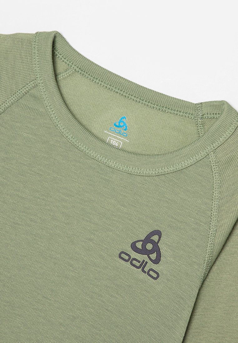 Grünes langärmeliges Odlo-Shirt mit Rundhalsausschnitt, sichtbaren Nähten und Odlo-Logo, das auf der Brust und im Krageninneren aufgedruckt ist.